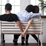 Young woman and man holding their hands behind the seat
